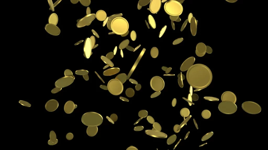 Gold coins falling from above against a dark background