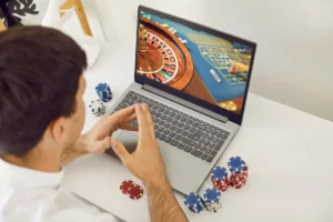 Man playing online casino games on his laptop.