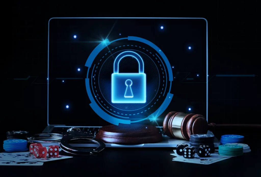 Laptop showing a padlock symbol surrounded by casino chips and cards.