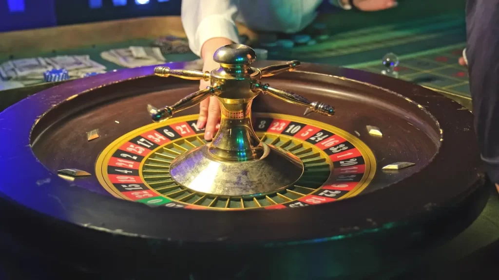 Croupier spinning a roulette wheel.